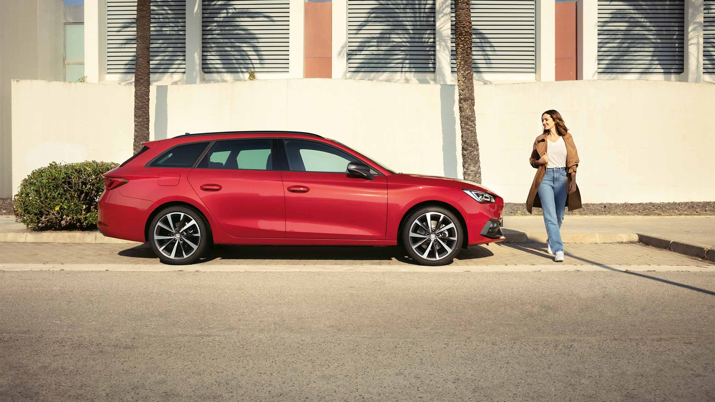 A red SEAT Leon SP Heather OW parked in a scenic outdoor location.